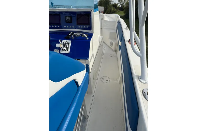 Slide: The Image of 2001 Fountain 31 Tournament Edition boat interior with blue and white seating and control panel. - 32
