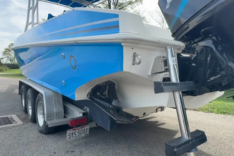 Slide: The Image of 2001 Fountain 31 Tournament Edition boat on trailer, blue and white design, rear view. - 33