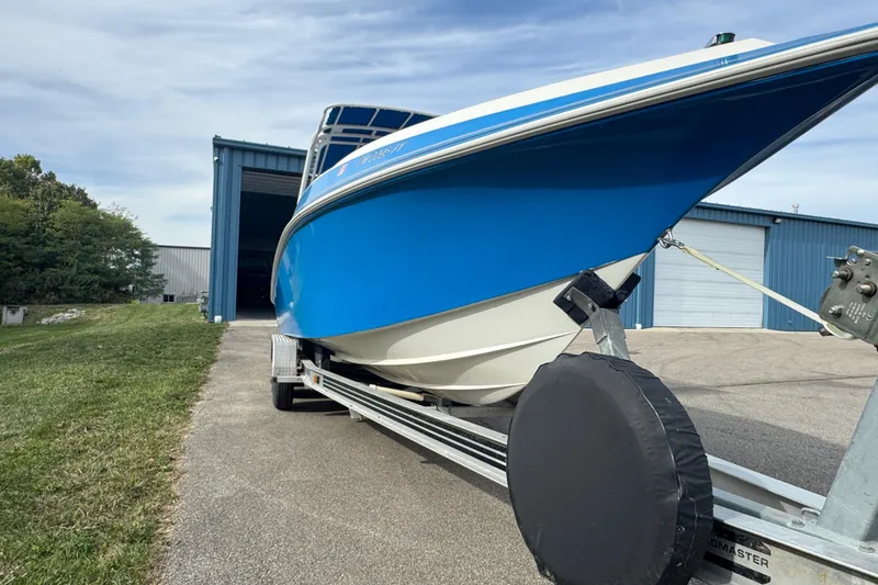 Slide: The Image of 2001 Fountain 31 Tournament Edition boat on trailer near blue storage building. - 6