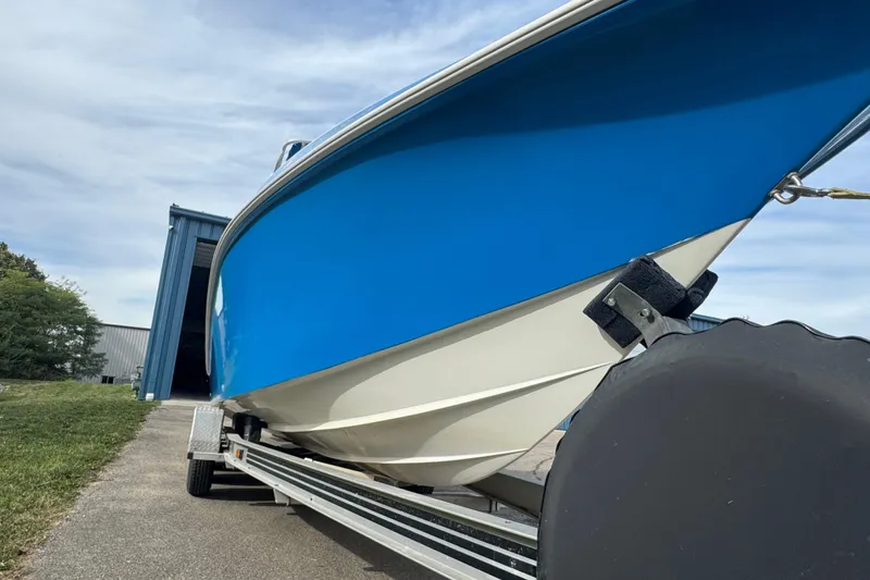 Slide: The Image of 2001 Fountain 31 Tournament Edition boat on trailer, blue and white hull. - 7
