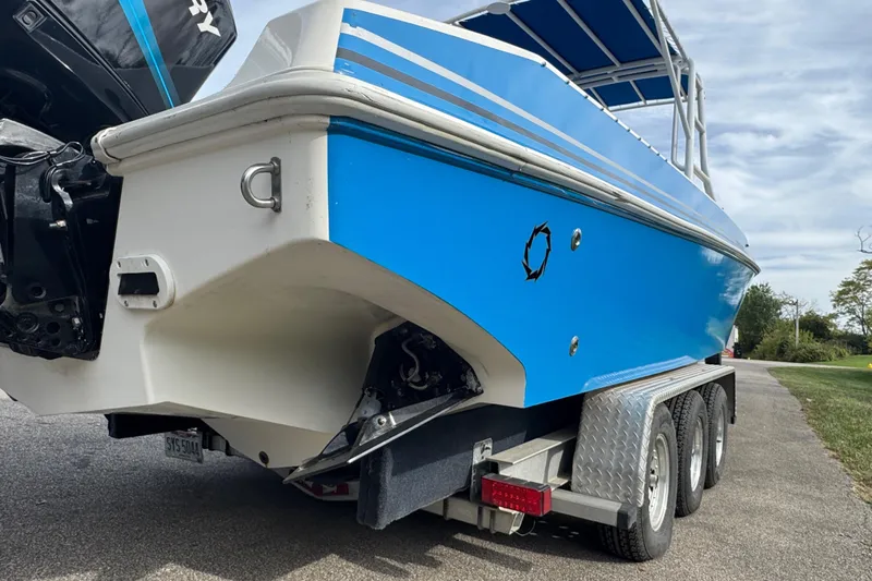 Slide: The Image of 2001 Fountain 31 Tournament Edition boat on trailer, featuring blue and white design. - 9