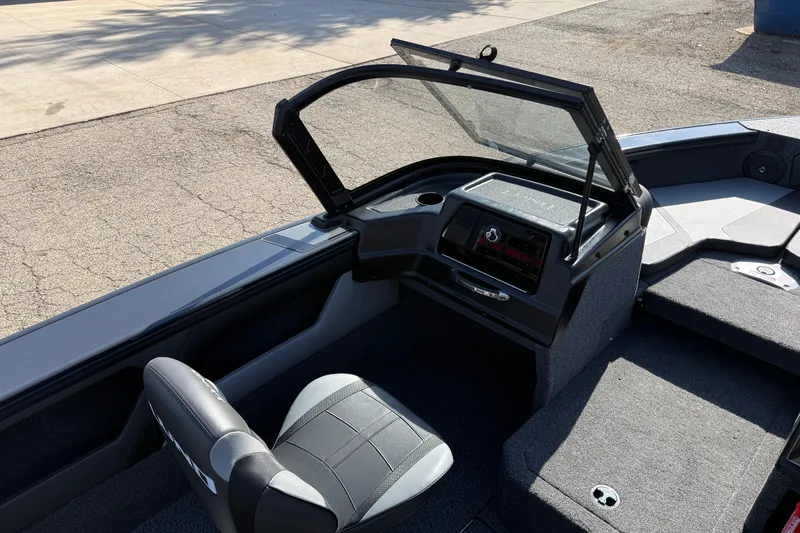 Slide: The Image of 2026 Lund 1875 Crossover XS boat interior with open windshield and seating. - 20