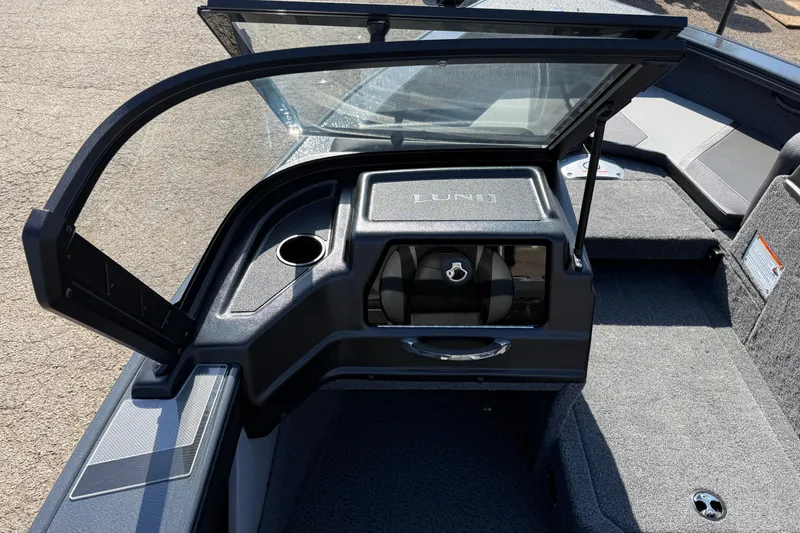 Slide: The Image of 2026 Lund 1875 Crossover XS boat interior with open windshield and storage compartment. - 21