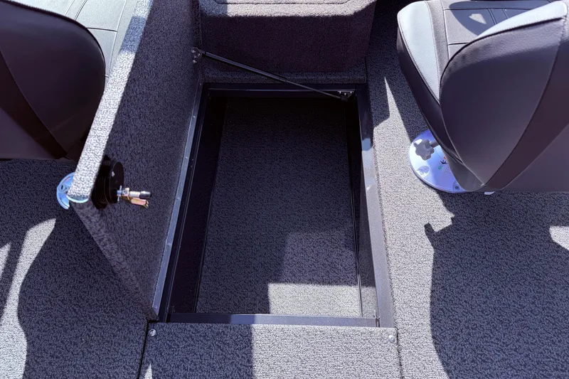 Slide: The Image of 2026 Lund 1875 Crossover XS boat interior with open storage compartment. - 24