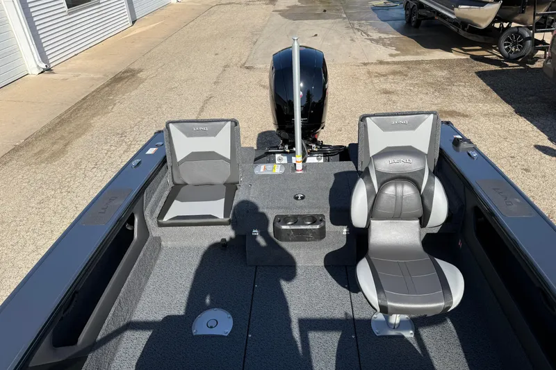 Slide: The Image of 2026 Lund 1875 Crossover XS boat interior with two seats and motor. - 25