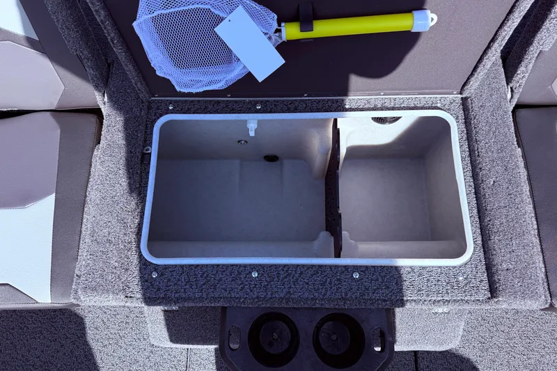 Slide: The Image of 2026 Lund 1875 Crossover XS boat storage compartment with net and yellow handle tool. - 29