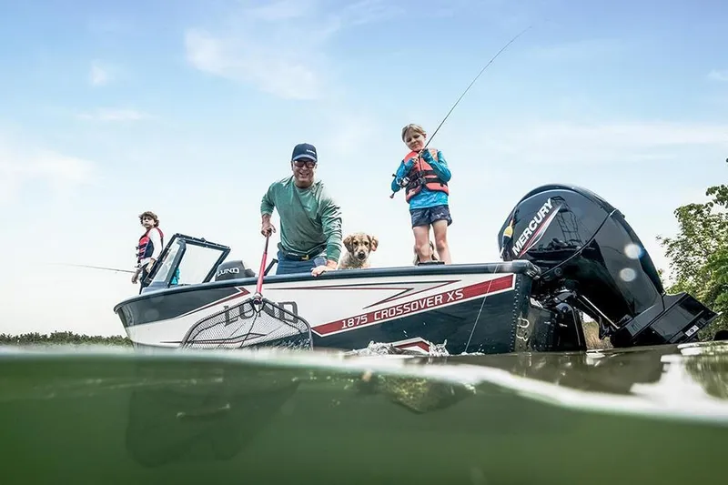 Slide: The Image of Manufacturer Provided Image: Family fishing on a 2026 Lund 1875 Crossover XS boat with a dog. - 3