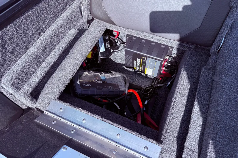Slide: The Image of Battery compartment of 2026 Lund 1875 Crossover XS boat with charger and cables. - 31