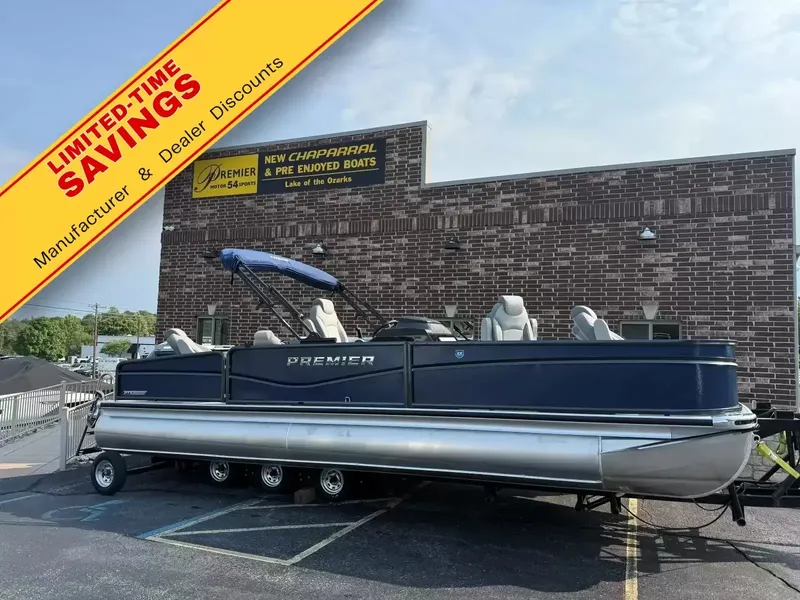 The Image of Premier 250 Sunsation Angler 6PT pontoon boat in a parking lot. A promotional banner advertises discounts. - 1