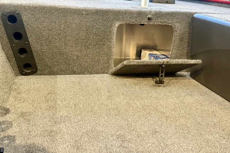 Slide: The Image of 2026 Tracker Bass Tracker Classic XL boat interior storage compartment with carpeted finish. - 15