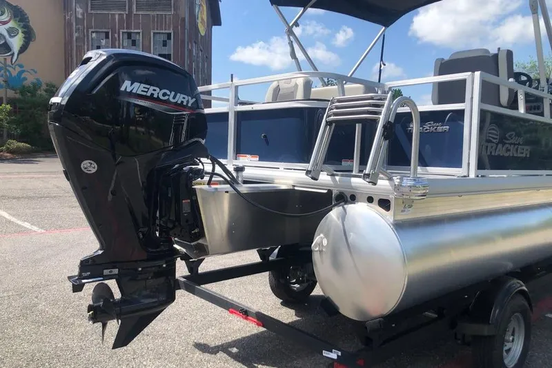 Slide: The Image of 2026 Sun Tracker Bass Buggy 18 DLX pontoon boat with Mercury outboard motor. - 2