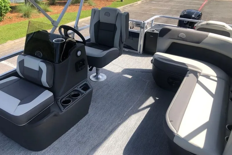 Slide: The Image of 2026 Sun Tracker Bass Buggy 18 DLX pontoon boat interior with seating and steering console. - 4