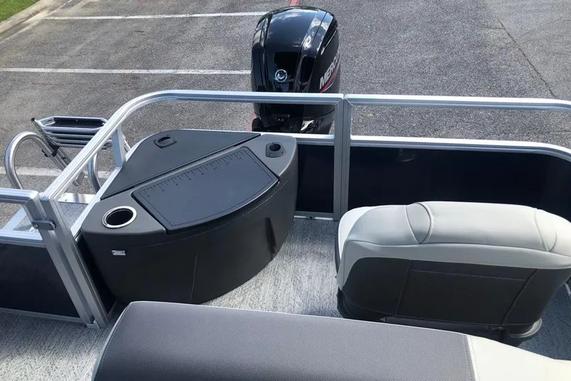 Slide: The Image of 2026 Sun Tracker Bass Buggy 18 DLX pontoon boat interior with seating and motor. - 6