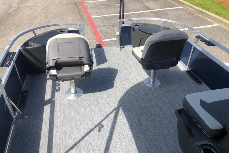 Slide: The Image of 2026 Sun Tracker Bass Buggy 18 DLX pontoon boat interior with seating and carpeted deck. - 7