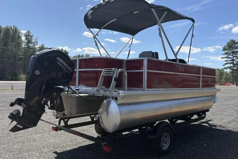 Slide: The Image of 2026 Sun Tracker Party Barge 18 DLX pontoon boat with canopy and outboard motor. - 5