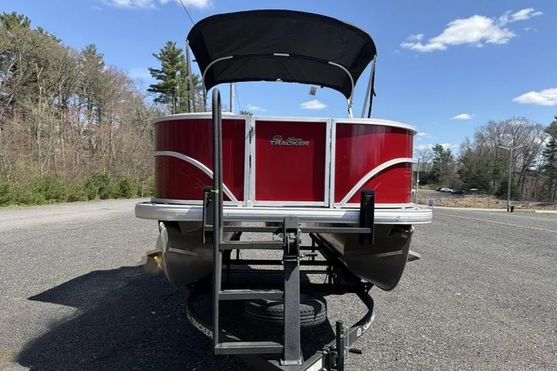 Slide: The Image of 2026 Sun Tracker Party Barge 18 DLX pontoon boat on trailer, parked outdoors. - 6