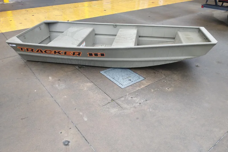 Slide: The Image of 2026 Tracker Grizzly 10 Jon boat on concrete surface, showcasing sturdy design. - 2
