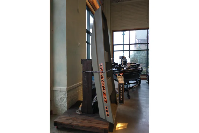 Slide: The Image of 2026 Tracker Grizzly 10 Jon boat displayed indoors, next to a window. - 7