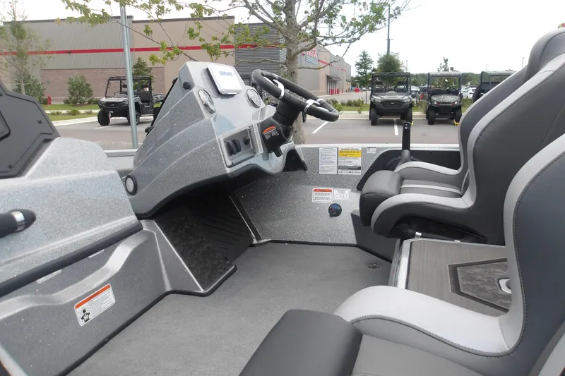 Slide: The Image of 2026 Nitro Z19 XL boat interior with modern dashboard and seating in a parking lot. - 10