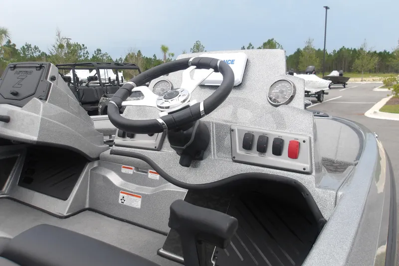 Slide: The Image of 2026 Nitro Z19 XL boat dashboard with steering wheel and control panel. - 11