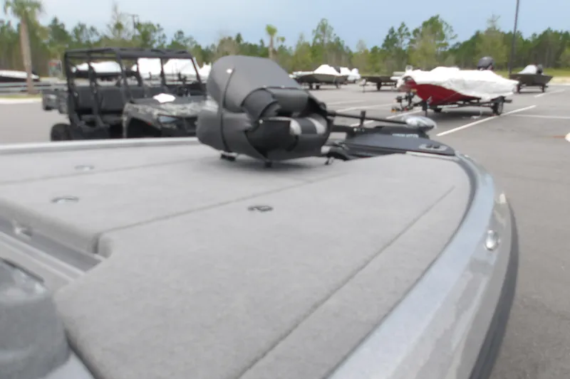 Slide: The Image of 2026 Nitro Z19 XL boat in parking lot, with covered boats and vehicles in background. - 12