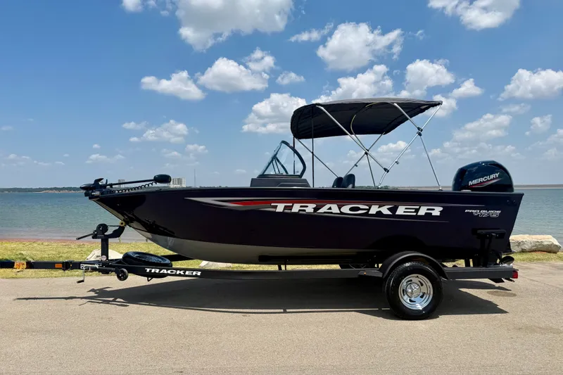 Slide: The Image of 2026 Tracker Pro Guide V-175 WT boat by a lake under a cloudy sky. - 23