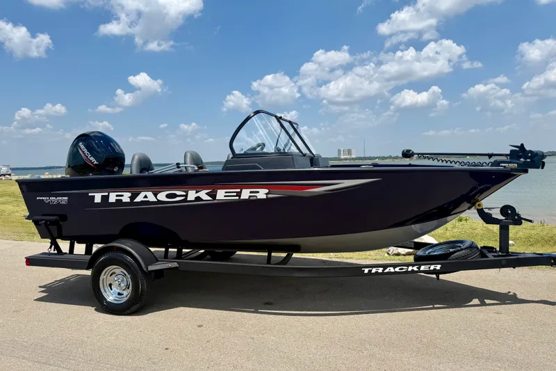 The Image of 2026 Tracker Pro Guide V-175 WT boat on trailer by lakeside under blue sky. - 0