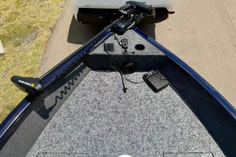 Slide: The Image of 2026 Tracker Pro Guide V-175 WT boat with Minn Kota trolling motor on carpeted deck. - 19