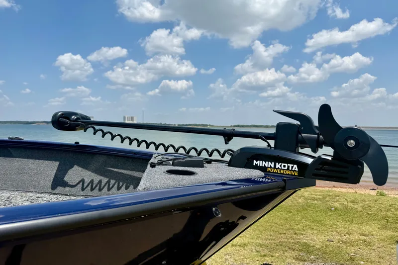 Slide: The Image of 2026 Tracker Pro Guide V-175 WT boat with Minn Kota PowerDrive motor by a lake. - 4