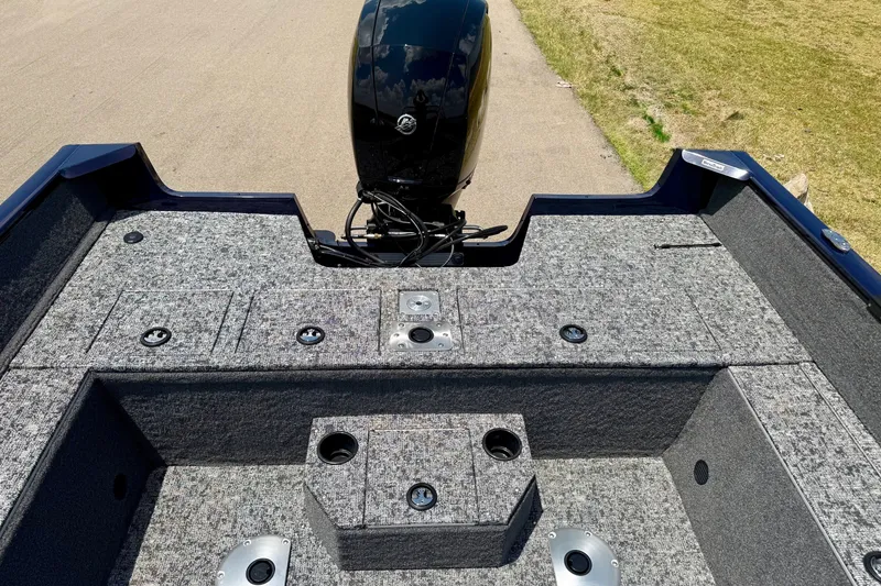 Slide: The Image of 2026 Tracker Pro Guide V-175 WT boat interior with motor, gray carpeted deck. - 8