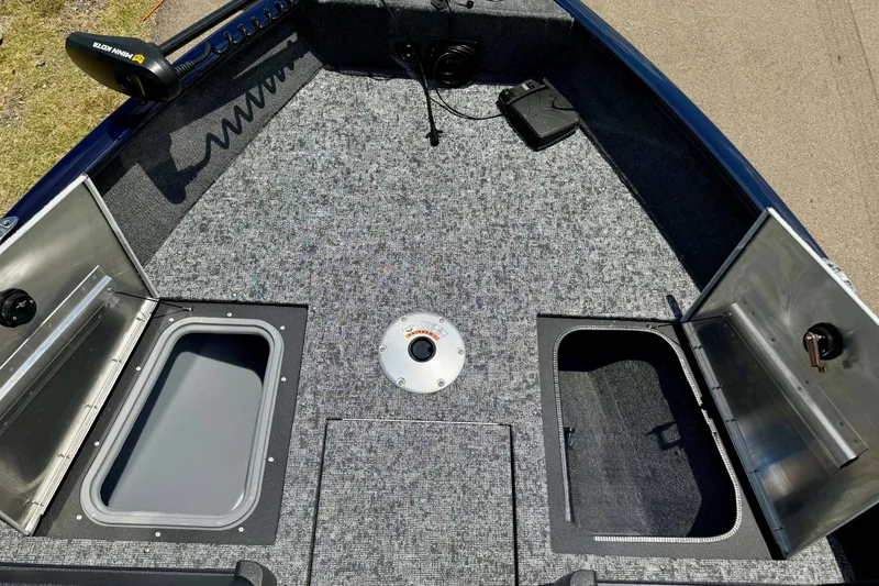 Slide: The Image of 2026 Tracker Pro Guide V-175 WT boat deck with storage compartments open. - 18