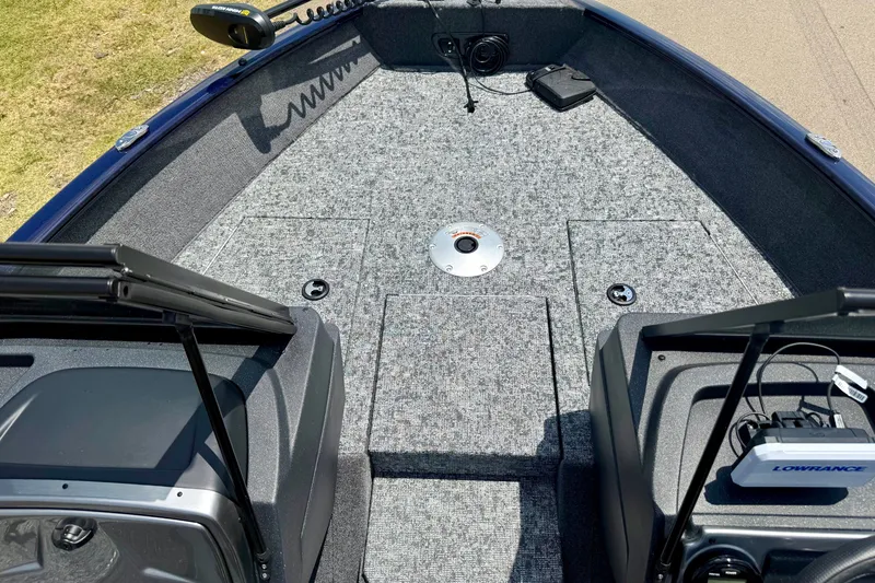 Slide: The Image of 2026 Tracker Pro Guide V-175 WT boat interior with carpeted deck and fishing equipment. - 13