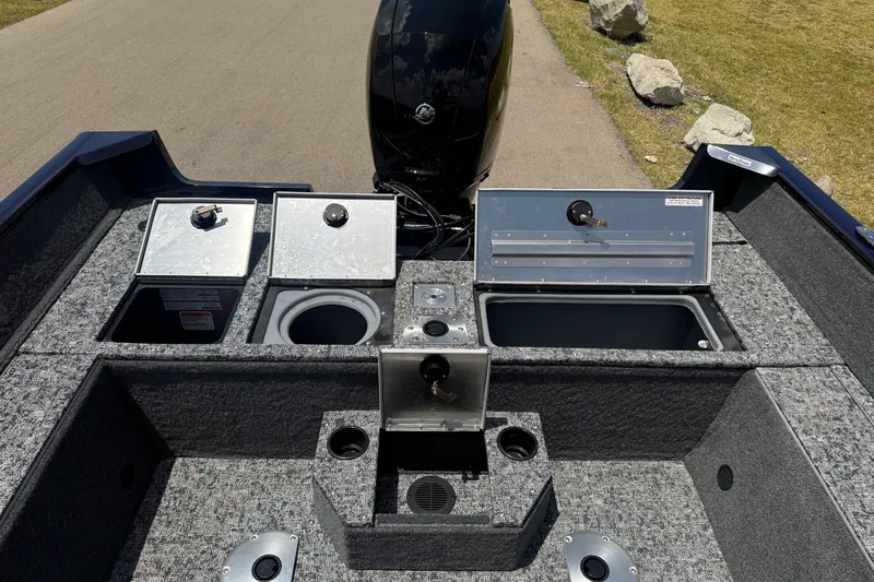 Slide: The Image of 2026 Tracker Pro Guide V-175 WT boat interior with storage compartments and motor. - 9