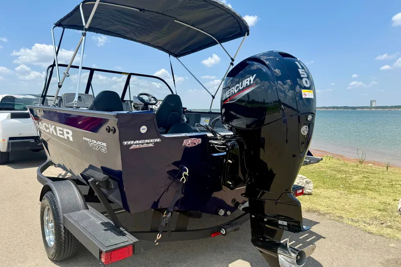 Slide: The Image of 2026 Tracker Pro Guide V-175 WT boat with Mercury engine by a lake. - 24