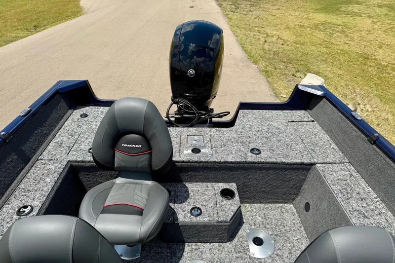 Slide: The Image of 2026 Tracker Pro Guide V-175 WT boat interior with seating and motor, on a sunny day. - 6