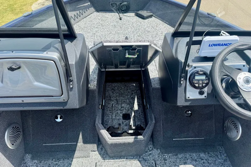 Slide: The Image of 2026 Tracker Pro Guide V-175 WT boat interior with steering wheel and storage compartments. - 14