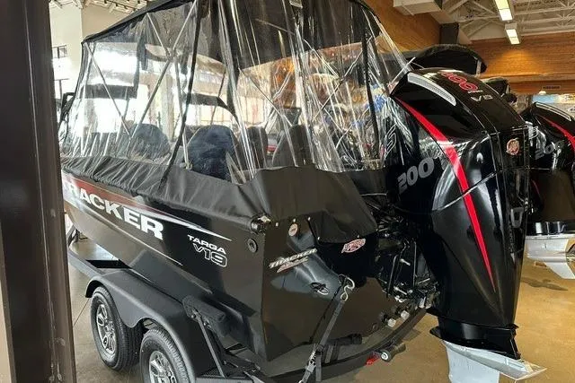 Slide: The Image of 2026 Tracker Targa V-19 Combo boat with dual engines in showroom. - 2