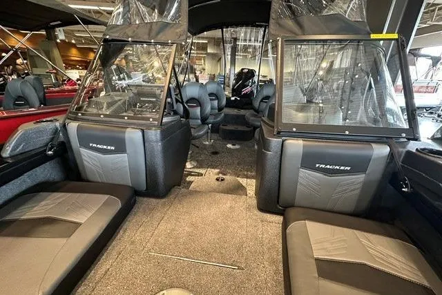 Slide: The Image of 2026 Tracker Targa V-19 Combo boat interior with seating and windshield in showroom. - 3