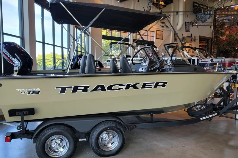 Slide: The Image of 2026 Tracker Targa V-18 WT boat displayed indoors, featuring a sleek design and modern amenities. - 85