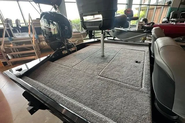 Slide: The Image of 2026 Tracker Bass Tracker Classic XL boat interior with carpeted deck and seating. - 10