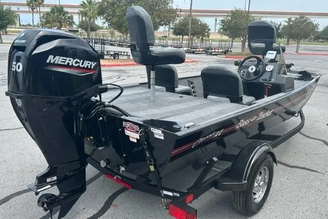Slide: The Image of 2026 Tracker Bass Tracker Classic XL boat with Mercury 50 engine in a parking lot. - 2
