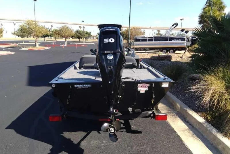 Slide: The Image of 2026 Tracker Bass Tracker Classic XL boat with 50 HP motor in parking lot. - 3