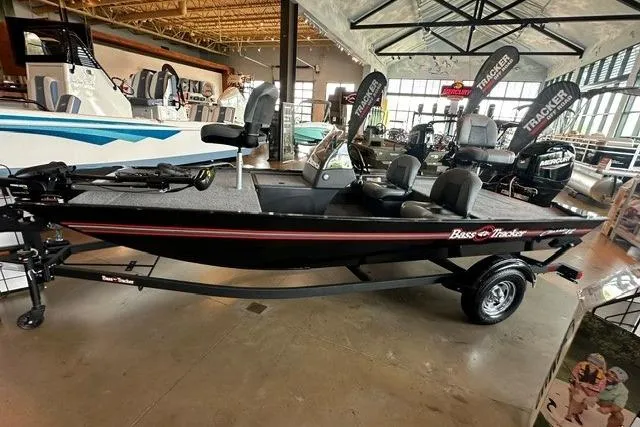 Slide: The Image of 2026 Tracker Bass Tracker Classic XL boat displayed in a showroom with modern interior. - 5