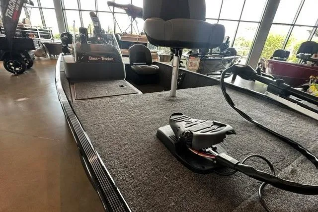 Slide: The Image of 2026 Tracker Bass Tracker Classic XL boat interior with carpeted deck and seating. - 7