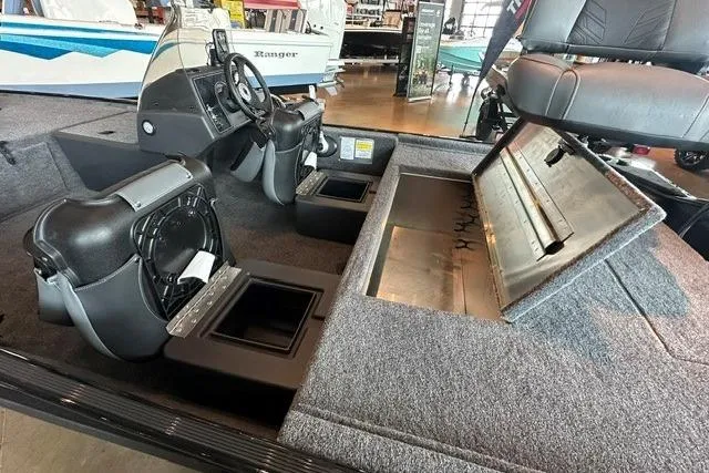 Slide: The Image of 2026 Tracker Bass Tracker Classic XL interior with storage compartments and seating. - 12