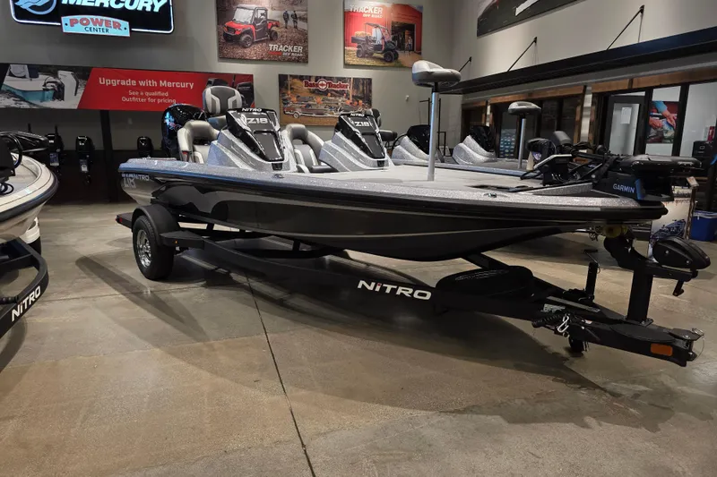 The Image of 2026 Nitro Z18 Pro fishing boat displayed in showroom with Mercury upgrade options. - 0
