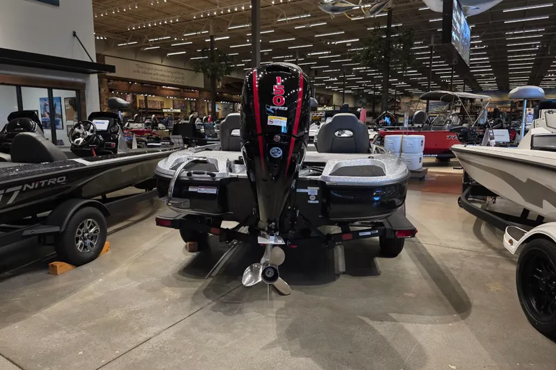 Slide: The Image of 2026 Nitro Z18 Pro boat displayed in a showroom with other boats. - 4