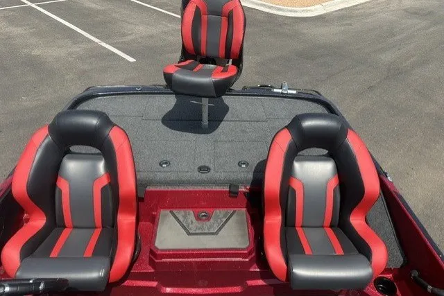 Slide: The Image of 2026 Nitro Z20 XL boat interior with red and black seats in a parking lot. - 12