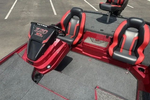 Slide: The Image of Red and black 2026 Nitro Z20 XL boat interior with dual seats and steering console. - 11