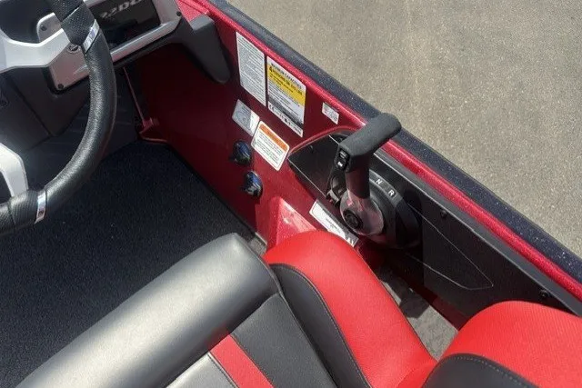Slide: The Image of Interior of 2026 Nitro Z20 XL boat with red and black seating and control panel. - 16